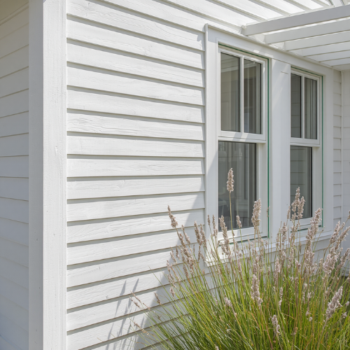 Granny flat cladding ideas — painted fibre cement sheeting on residential exterior wall, smooth white finish